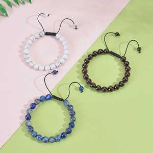 Detailed view of woven bracelets with white, mahogany, and lapis lazuli natural beads