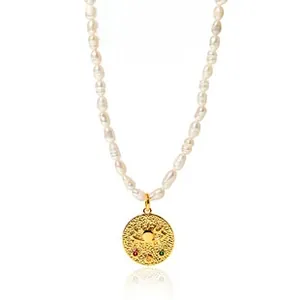 Macro shot of baroque pearl necklace with gold evil eye pendant and hammered texture