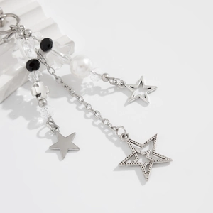 Detail of beaded phone strap with silver star pendants and faceted black crystal beads