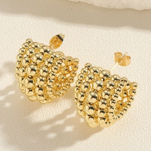Close-up of golden CCB cluster bead earrings with polished spherical surface detail