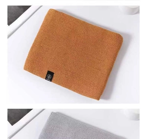 Detailed knit texture of thick winter neck warmers in vibrant orange and classic grey colors