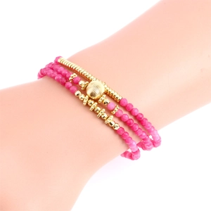 Detailed macro view of triple-layered pink chalcedony beads with gold-plated accents