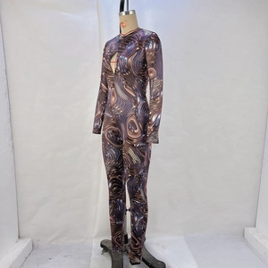 Detail of slim fit jumpsuit featuring brown 3D liquid metal swirl print on elastic fabric