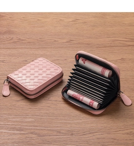 Pink woven leather card holder with accordion slots and secure zipper closure detail