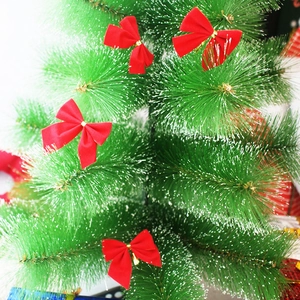 Set of four small red flocked Christmas bows attached to green festive tree branches