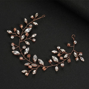 Close-up of handmade rose gold bridal hair vine with sparkling crystals and metal wire