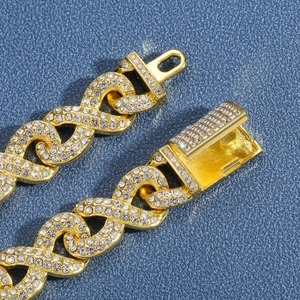 Macro view of gold-plated iced-out Cuban chain links with premium rhinestone inlay
