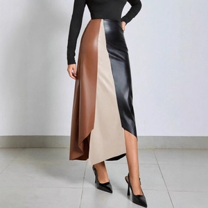 Detail of high-waisted PU leather patchwork skirt with brown, beige, and black panels
