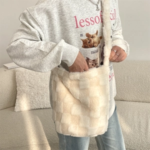 Close-up of soft plush texture and checkerboard pattern on the cream shoulder bag
