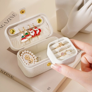 Portable cream jewelry box with ring slots and earring panel in travel friendly size