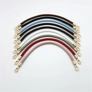 Various colors of PU leather bag straps with golden metal hooks arranged in an arc