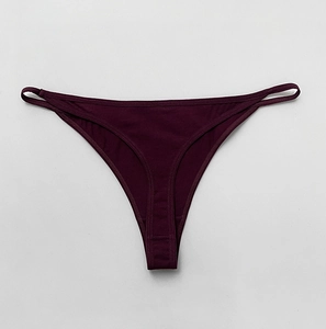 Detail of deep purple cotton T-back thong featuring a slim elastic waistband and soft fabric