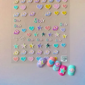 Macro detail of 5D embossed nail stickers featuring colorful star and planet motifs