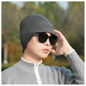 Winter rib-knit beanie in dark grey styled with black sunglasses and a zip-up sweater