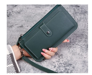 Close-up of a dark green long multifunctional wallet with zipper and snap button closure