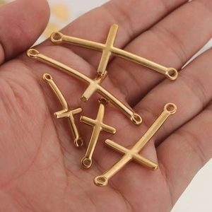Gold plated stainless steel curved cross connectors for DIY jewelry making in hand