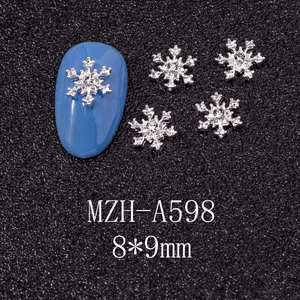 Detailed view of silver alloy snowflake nail charms with center crystal and 8x9mm size
