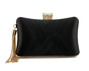 Detail of black evening clutch with woven texture, crystal buckle and gold tassels
