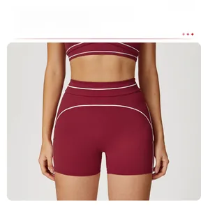 Detailed side view of high-waisted burgundy sports shorts with white contrast stitching