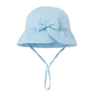 Detailed texture of blue cotton baby sun hat with bow decoration and adjustable strap