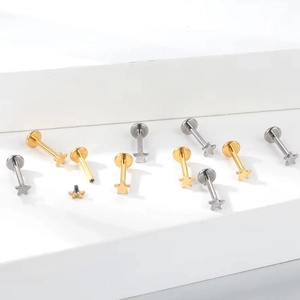 Detail of titanium flat back studs showing star shape and internal threading mechanism
