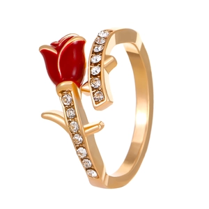 Macro detail of red rose enamel ring with gold thorns and sparkling white diamonds
