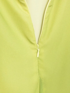 Close-up of lime green dress showing invisible zipper and fine fabric texture details