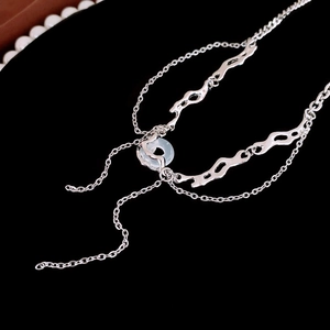 Detailed macro view of irregular silver chain with a translucent teal resin ring pendant