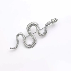 Luxurious vintage silver snake brooch with detailed scales texture on white background