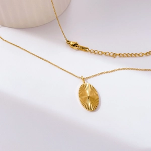 Detail of 18K gold-plated necklace clasp showing K18 stamp and lobster claw closure