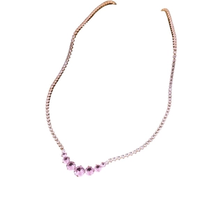 Rose gold necklace with gradient pink zircon stones on a clean white background