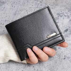 Close-up of black lychee grain men's wallet with gold plate held in a model's hand