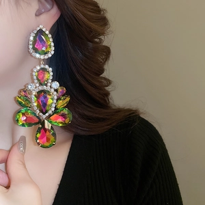 Close-up of dangling colorful teardrop earrings with AB crystal fringe on model