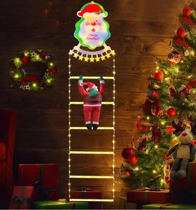 Detail of LED Santa climbing ladder lights on dark wood with Merry Christmas greeting