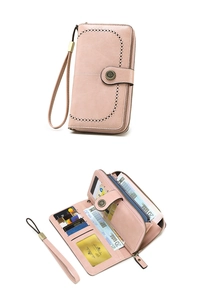 Macro view of a pink long wallet with multiple card slots and metal button detail