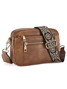 Detail of deep brown crossbody bag with multi-layer zipper and floral embroidered strap