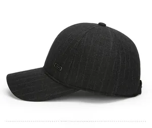 Detail of dark grey wool baseball cap with vertical stripes and side metal plate