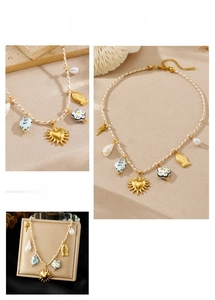 Detail of woven rope necklace with sun heart, ceramic fish, flower, pearl and shell charms