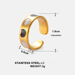 Detail of adjustable gold stainless steel ring with white and grey enamel hearts