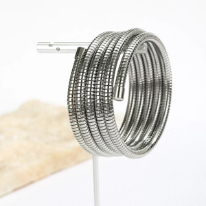 Minimalist multi-layer stainless steel coil bracelet in polished silver on display stand