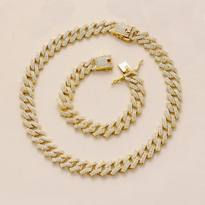 Detail view of 15mm gold Cuban link necklace and bracelet set with iced-out rhinestones