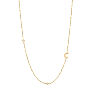Close-up of golden S925 silver initial C pendant with sparkling diamonds on a fine chain
