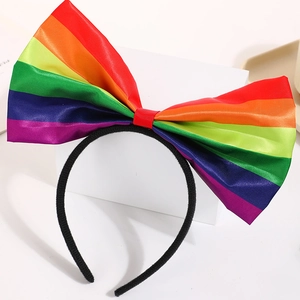 Rainbow bow headband with vibrant satin stripes for pride events or colorful costume wear