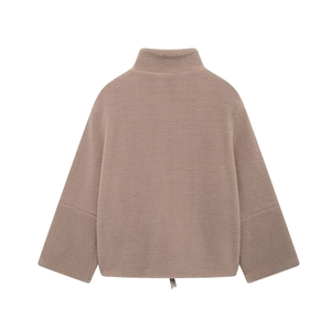 Detail view of the plush camel teddy fleece fabric and adjustable drawstring hem on jacket