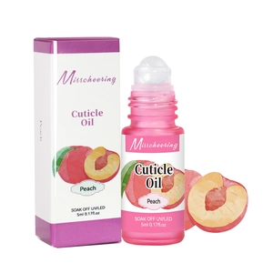 Close-up of a 5ml peach scented cuticle oil roll-on pen with branded packaging box