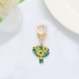 Detail of sunflower bouquet charm with yellow enamel finish and golden heart-shaped clasp