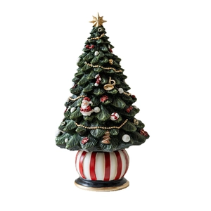 Rotating Christmas tree music box with red and white striped base and gold star topper