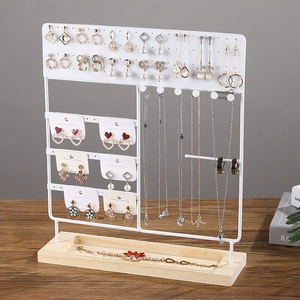 Multi-tier jewelry display stand with white metal hooks and a grooved wooden base
