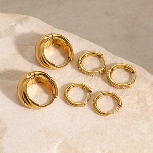 Three-piece gold stainless steel hoop earring set with minimalist and crystal designs