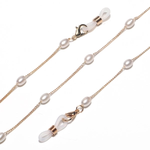 Detailed view of golden eyewear chain with white pearls and silicone anti-slip loops